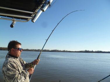 Night Stalker Guide Service - A man on a catfish charter fishing boat.